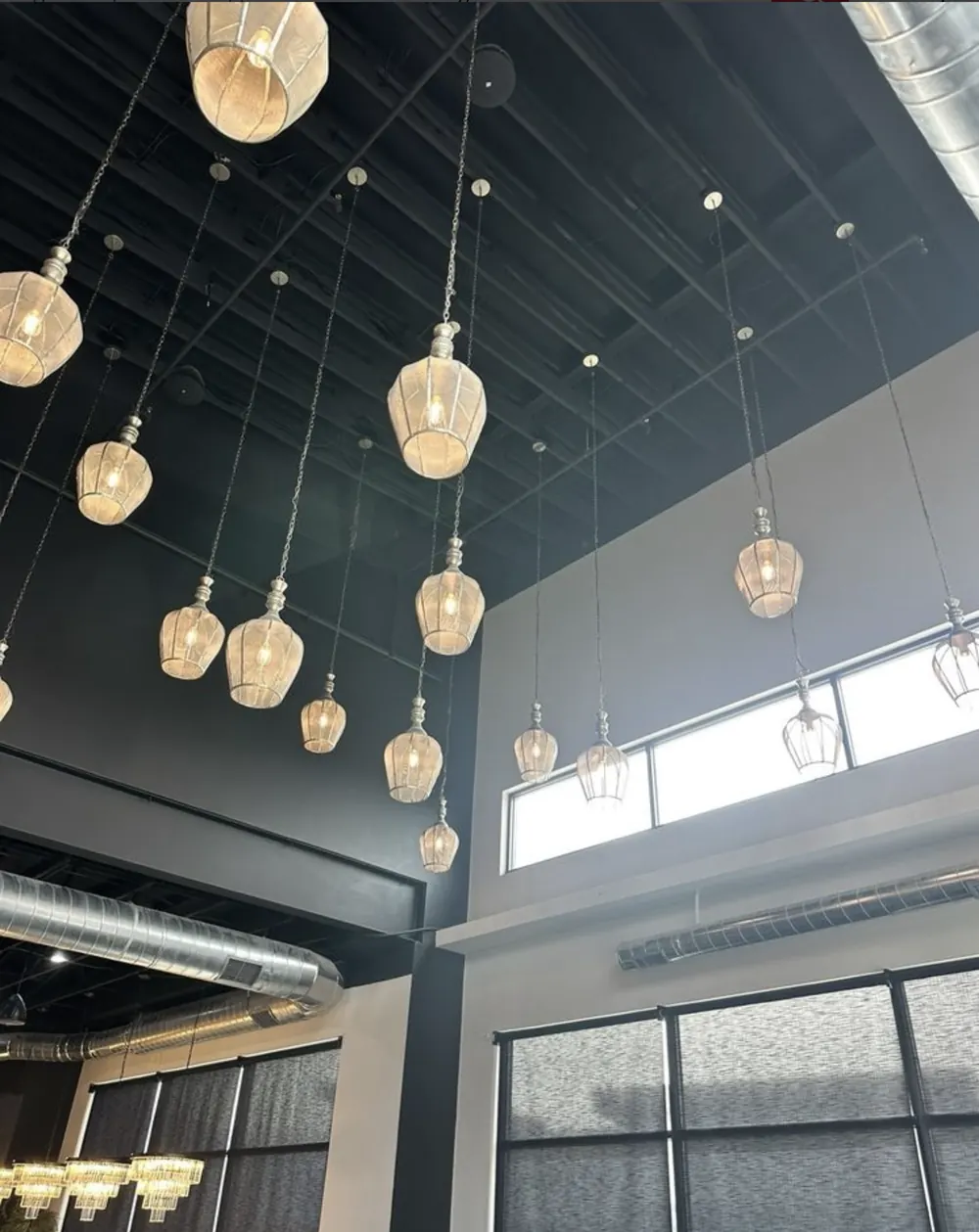 Pendant lights and exposed metal ductwork inside Urban Kitchen
