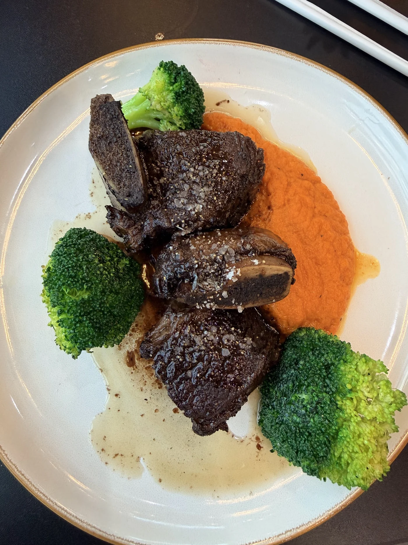 Braised beef short ribs with carrot-ginger purée and sautéed broccoli at Urban Kitchen