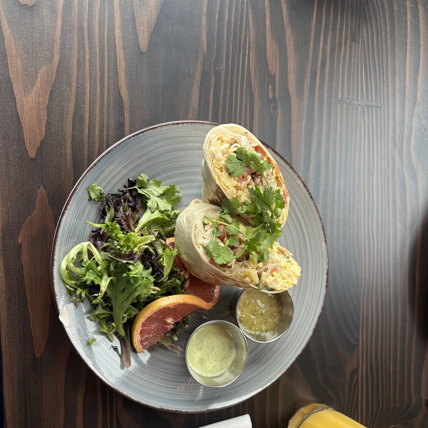 Breakfast burrito with fresh greens, salsa, and grapefruit at Urban Kitchen