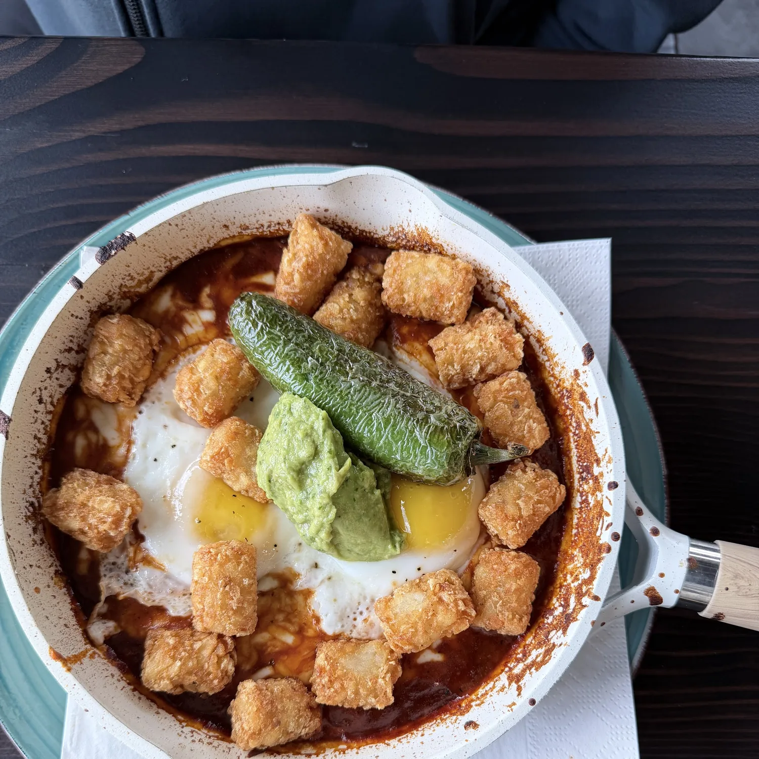 Urban skillet with eggs, tater tots, guacamole, and ranchero sauce at Urban Kitchen